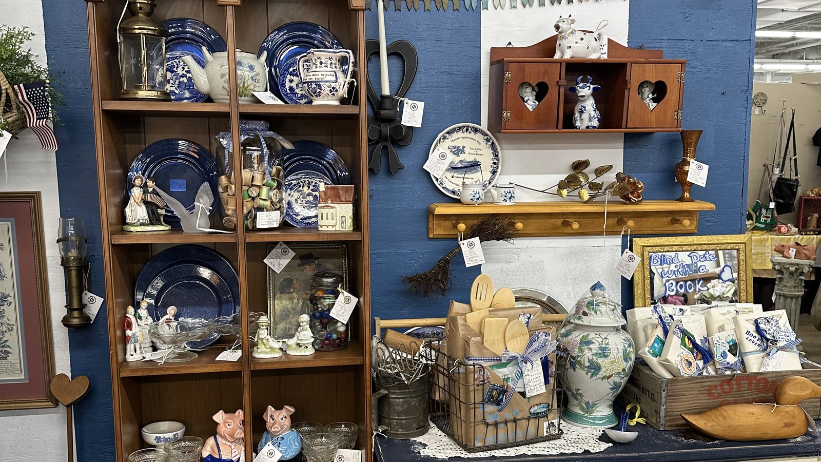Blue-and-white dish display with shelves, pottery, and tabletop pieces inside Antiques Village