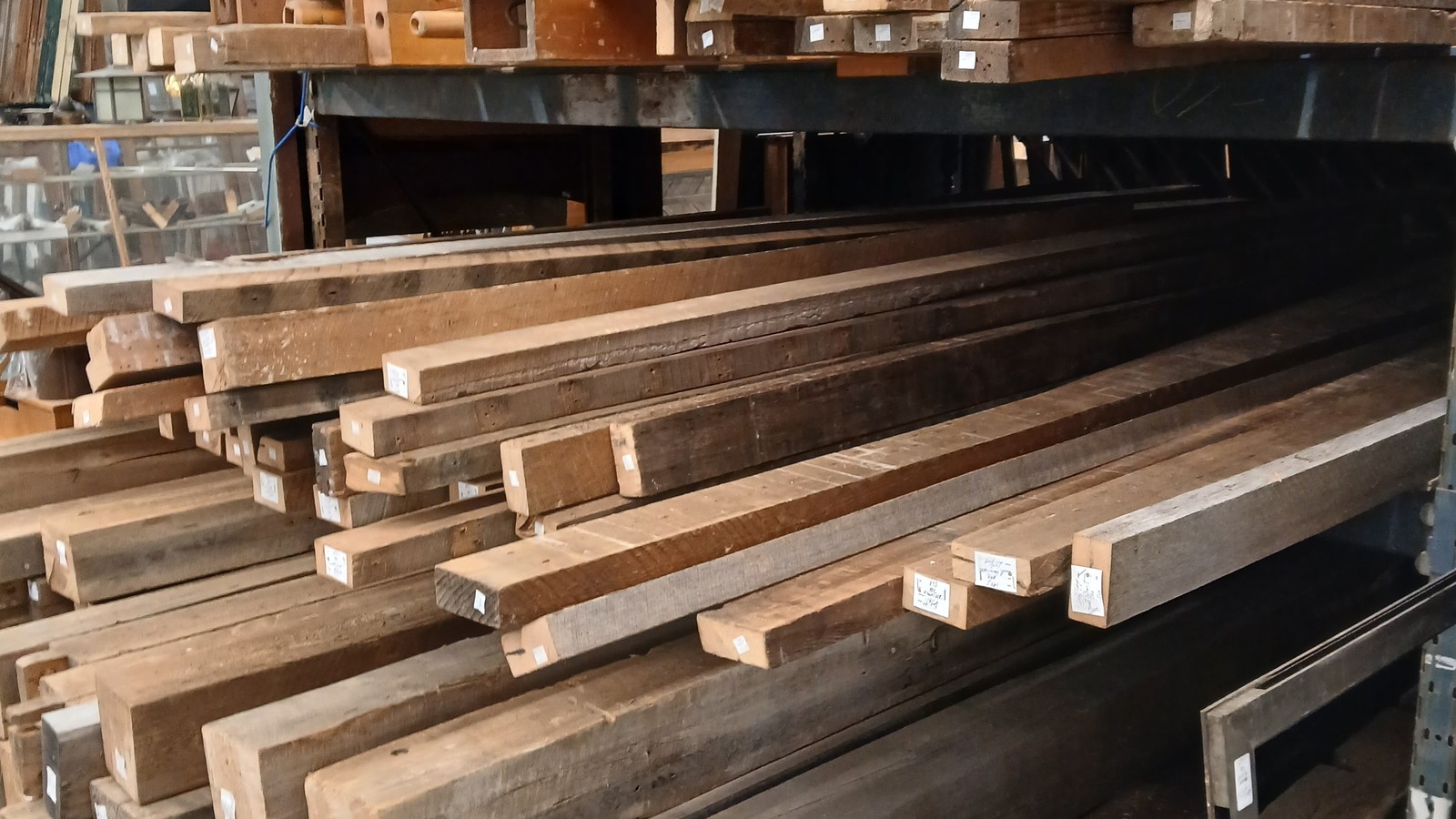 Long racks of reclaimed lumber stacked inside the Dayton Reclamation area at Antiques Village