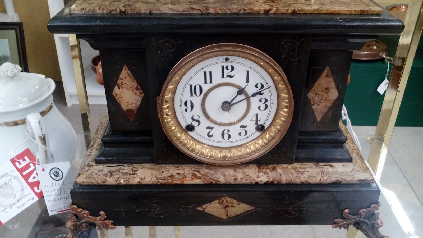 Marble mantel clock displayed in a glass case at Antiques Village in Dayton