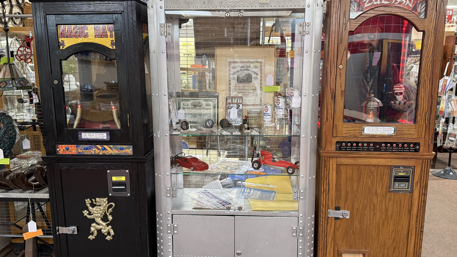 Arcade cabinets and glass display cases standing side by side at Medina Antique Mall
