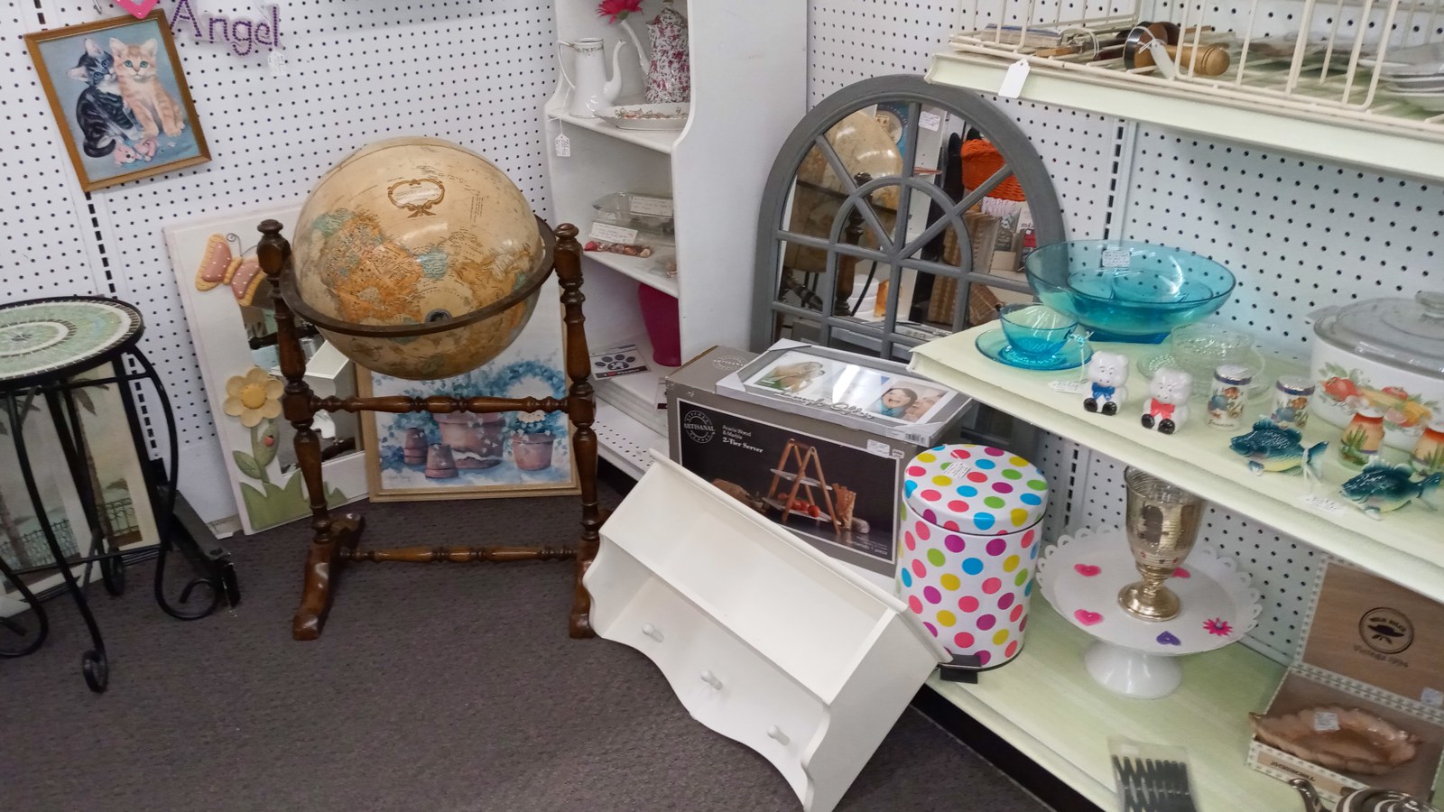 Globe stand, pastel glass bowls, and painted accents inside Maumee Antique Mall
