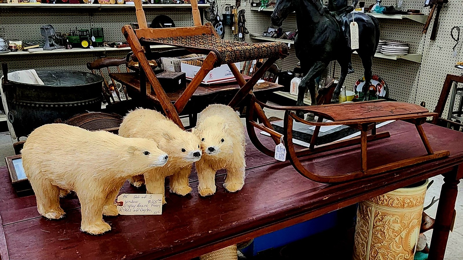 Bear figures, wooden bench, and folk-art display inside Maumee Antique Mall
