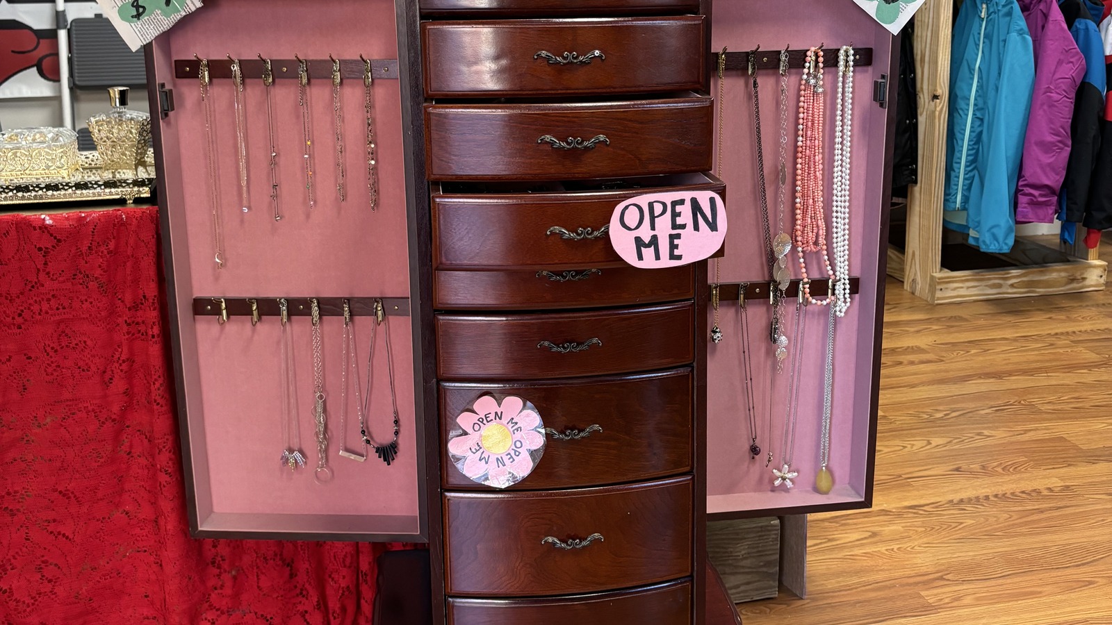 Open jewelry cabinet and small accessories display inside Khlovan's Thrift