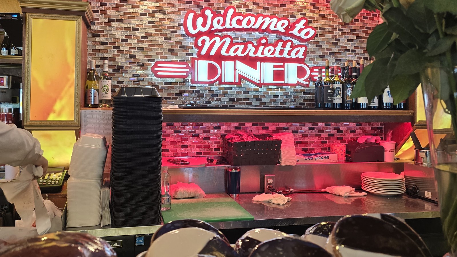 Welcome to Marietta Diner neon sign glowing inside the dining room