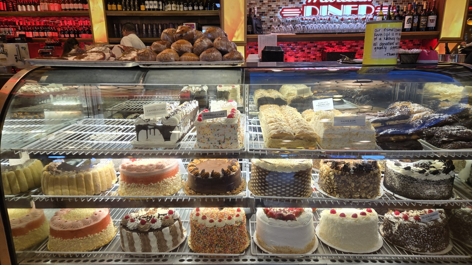 Dessert case filled with cheesecakes and pastries at Marietta Diner