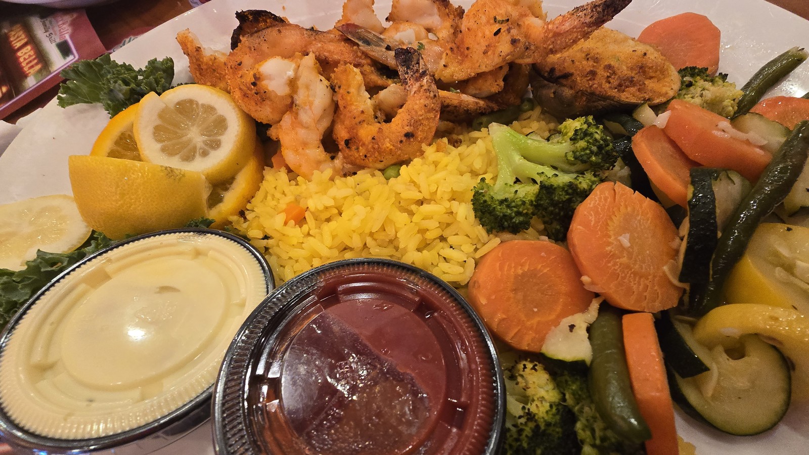 Greek-style platter with rice, vegetables, and grilled seafood at Marietta Diner