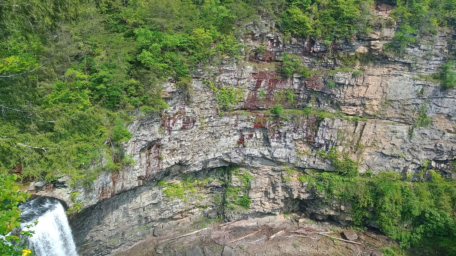 Main plunge pool and pale cliff face opening wide below the falls.