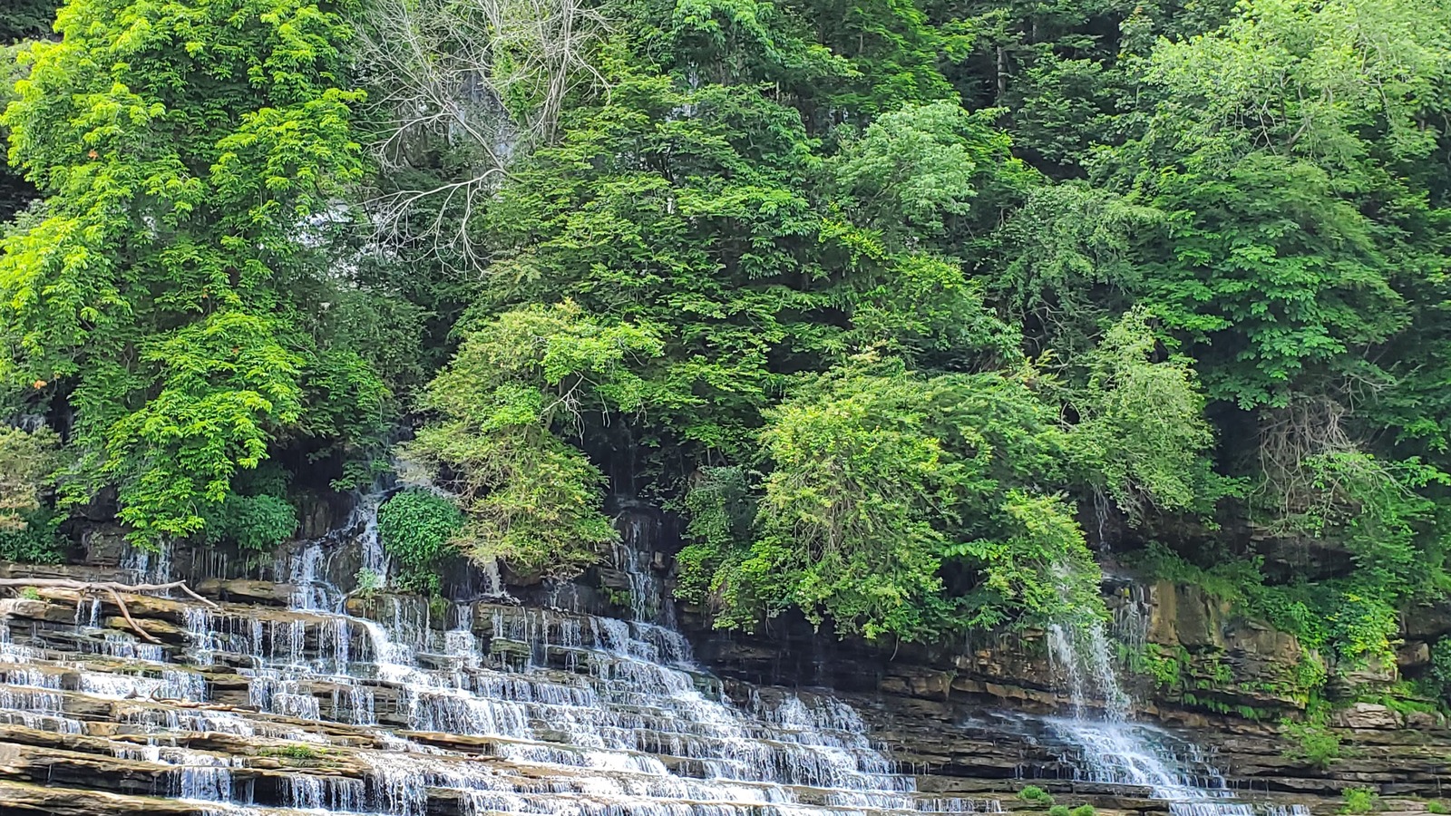 Long limestone terraces carrying bright ribbons of water at Rock Island State Park.