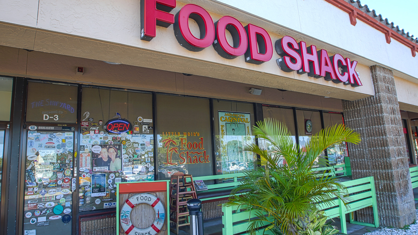 Little Moir's Food Shack sign above the front patio and sticker-covered windows in Jupiter