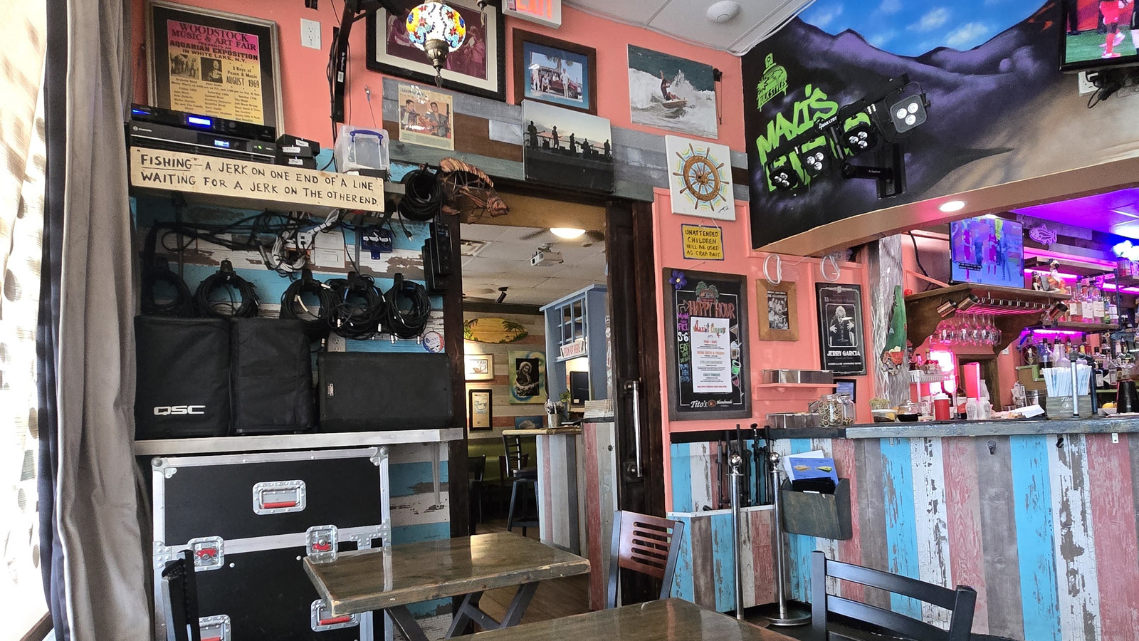 Colorful corner tables and mural-painted bar area inside Little Moir's Food Shack