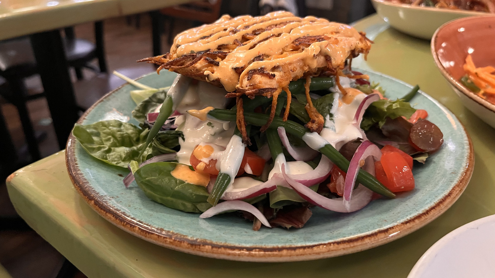Sweet potato-crusted fresh catch served over greens at Little Moir's Food Shack