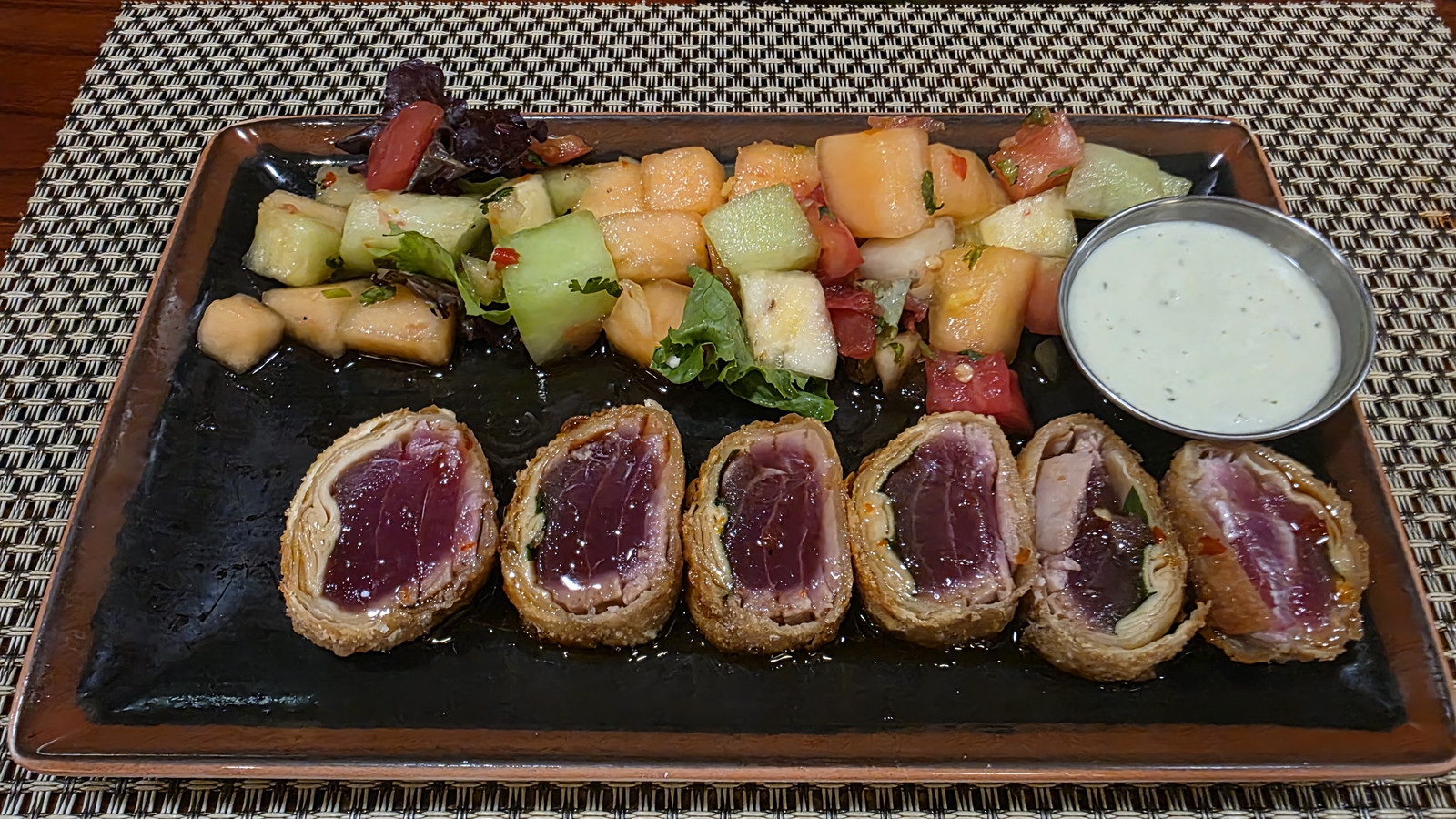 Fried tuna and basil roll with fruit salad and dipping sauce at Little Moir's Food Shack
