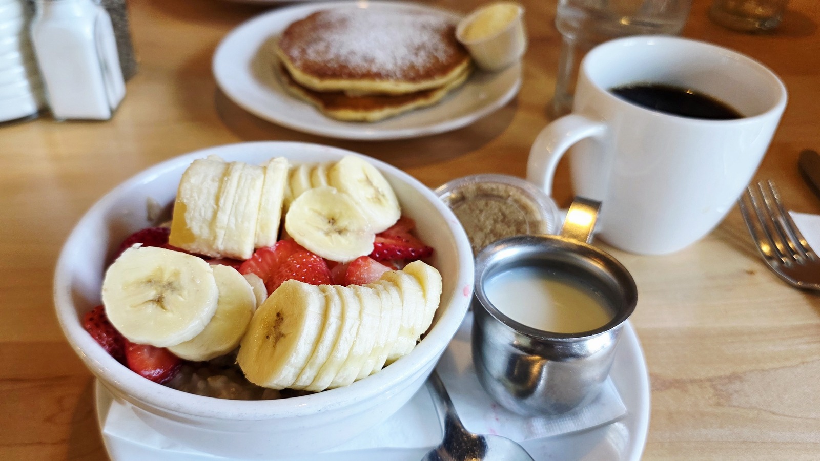 Fruit bowl with pancakes and coffee at Butters Pancakes & Cafe