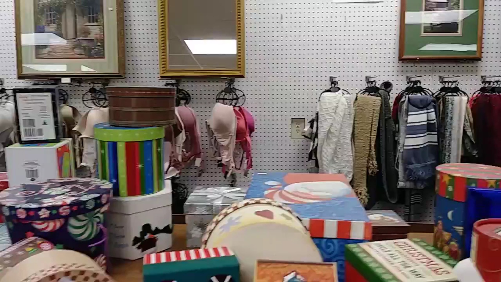 Colorful housewares and clothing displays inside Harvest Thrift Store in Wilmot