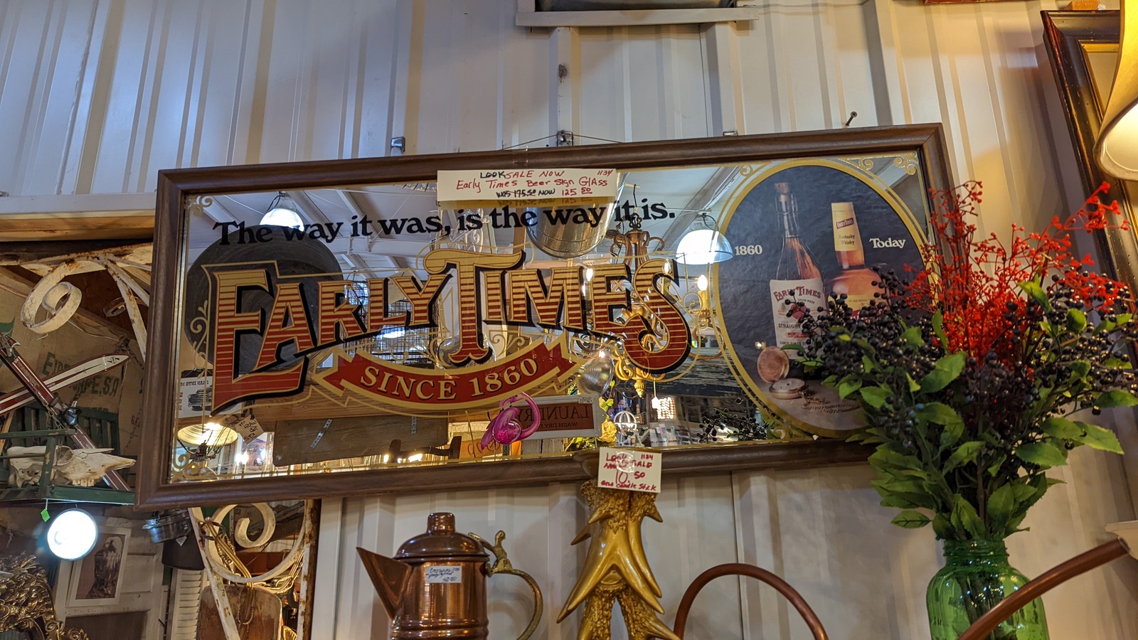 Vintage Fair Times sign, floral arrangement, and antiques at Briar Patch Market