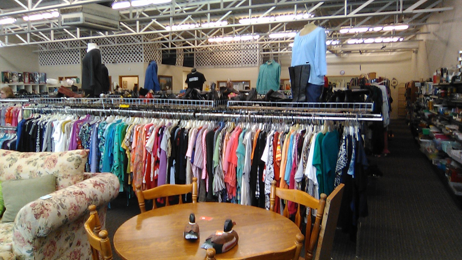 Colorful clothing racks and furniture inside St. Joseph Social Care and Thrift in Grand Forks