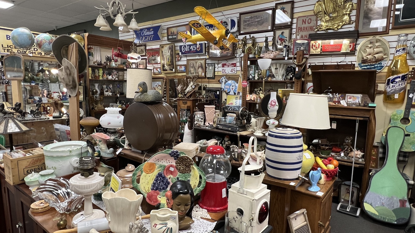 Collectibles, lamps, framed art, and vintage decor inside Plain and Fancy Antique Mall in Grand Forks