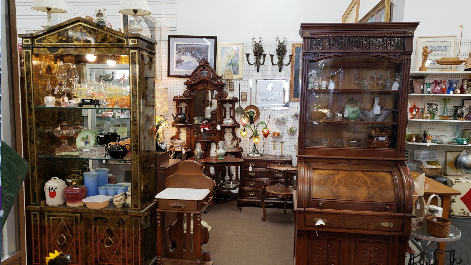 Antique cabinets, clocks, furniture, and decor inside Saugatuck Antique Pavilion near Saugatuck