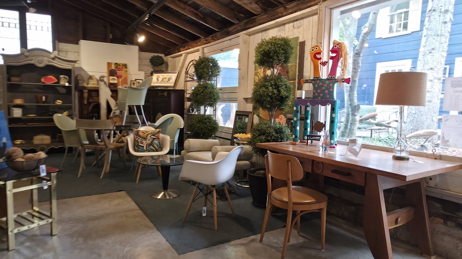 Furniture, lamps, art, and home accents inside Upscale Mercantile near Saugatuck