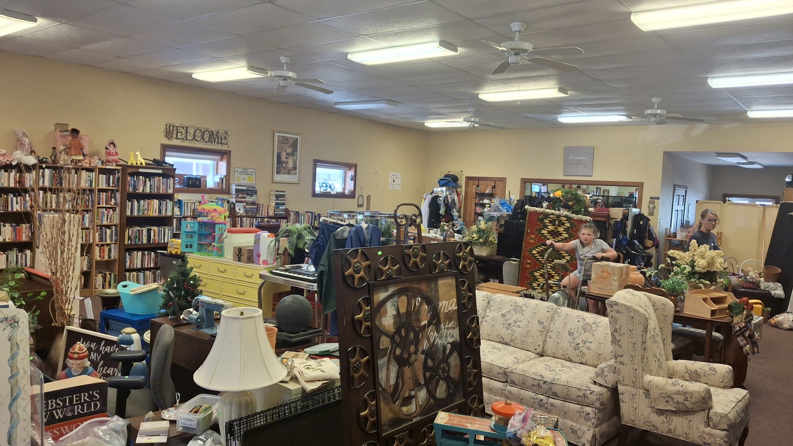 Furniture, books, and home accents inside This and That Thrift Shop in Orange City