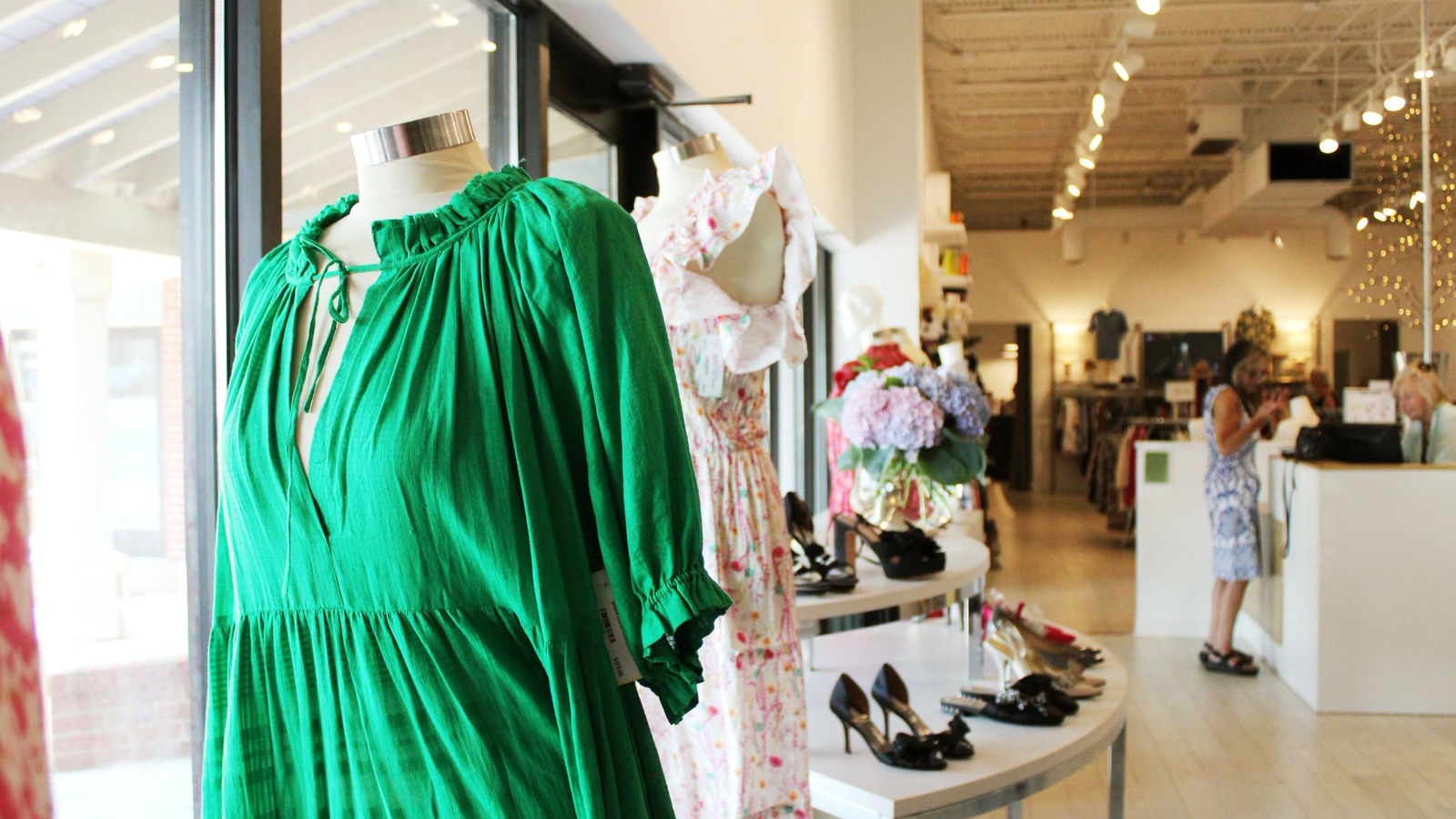 Green dress, floral dress, and shoes inside Frugalicious in Easton