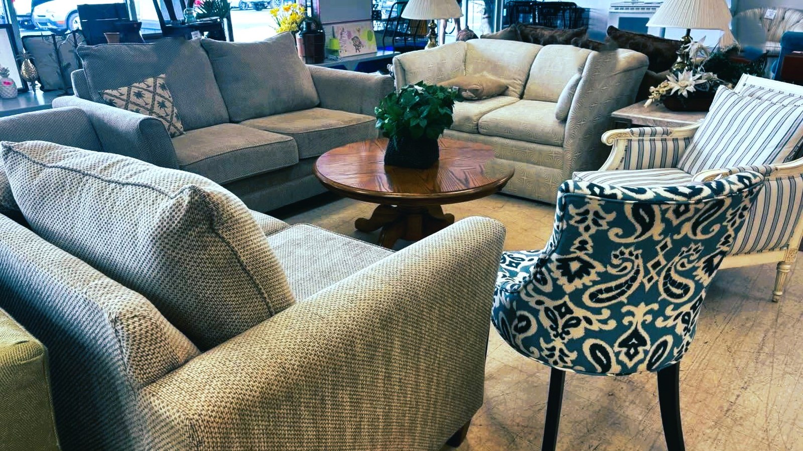 Sofas, chairs, and tables on the Second Chance Resale Store furniture floor