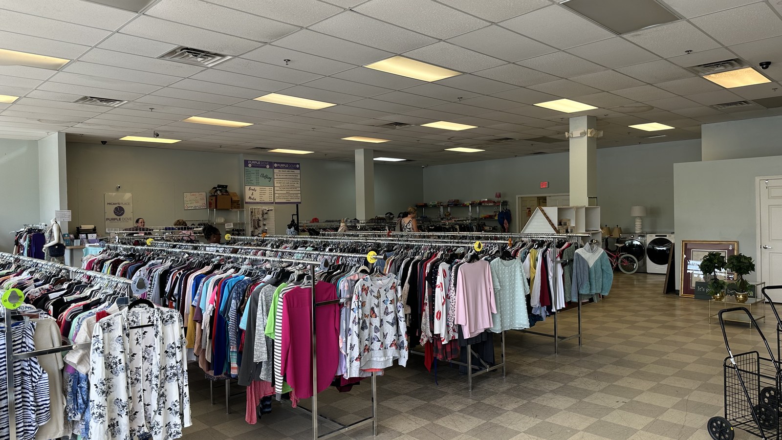 Organized clothing racks inside Purple Dove Resale Center