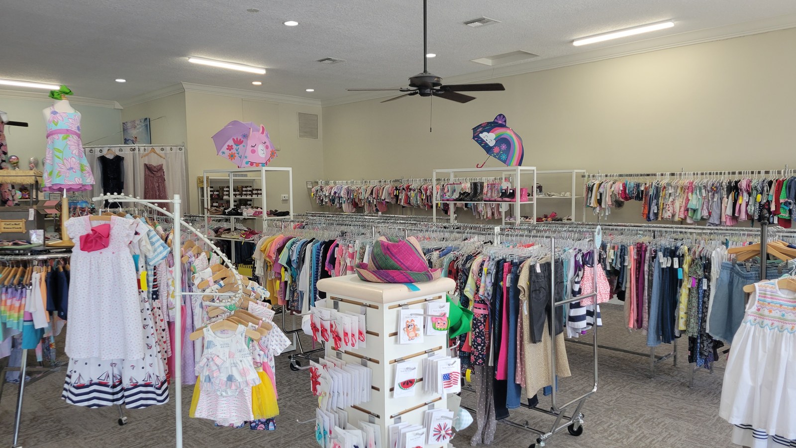 Children's clothing and baby gear arranged inside Wiggle Worms