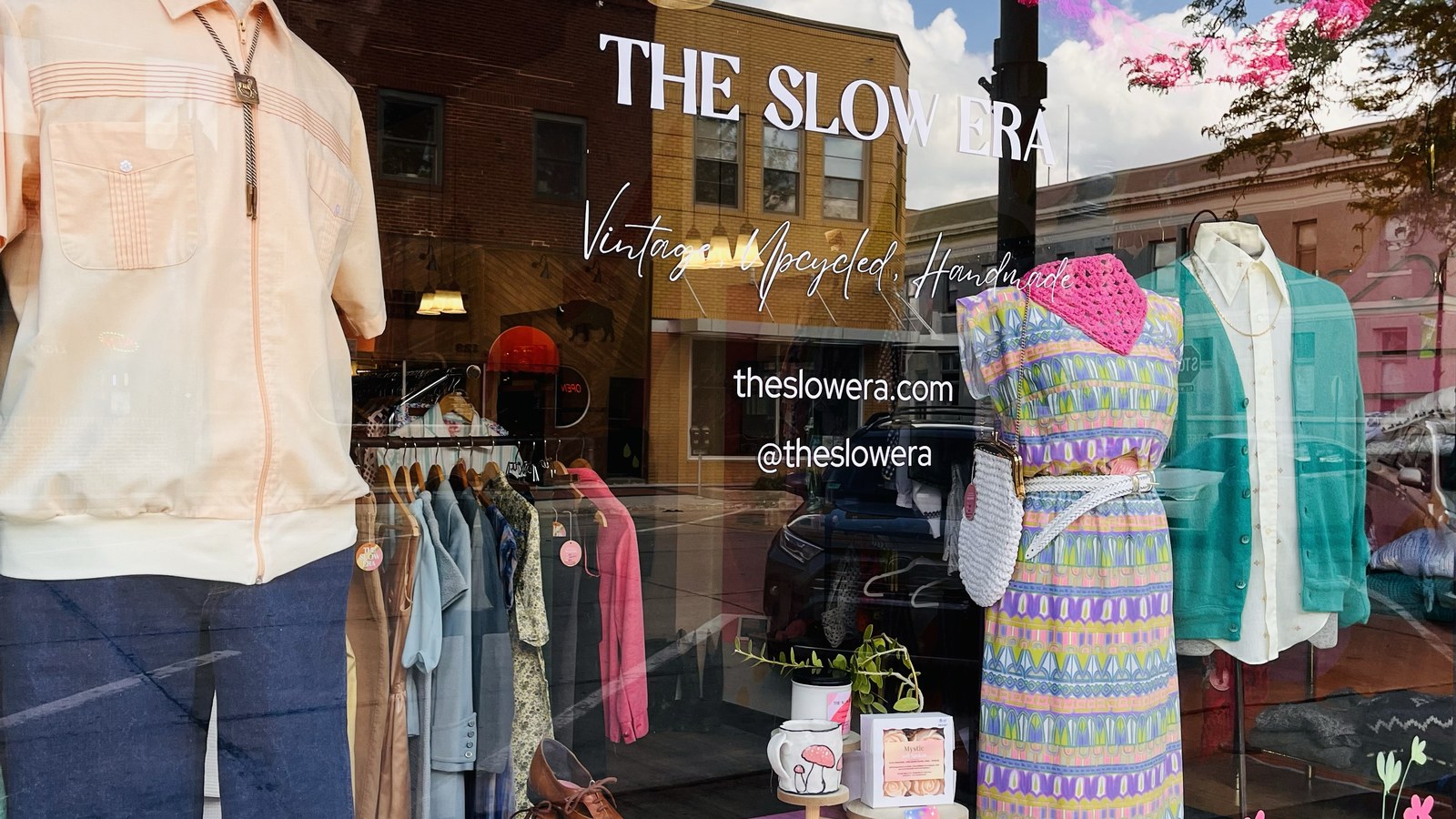 Vintage outfits displayed outside The Slow Era on Main Street
