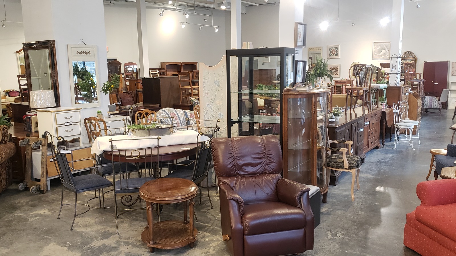 Sofas, tables, chairs, and wood furniture inside Revival Home Furnishings near Lenexa