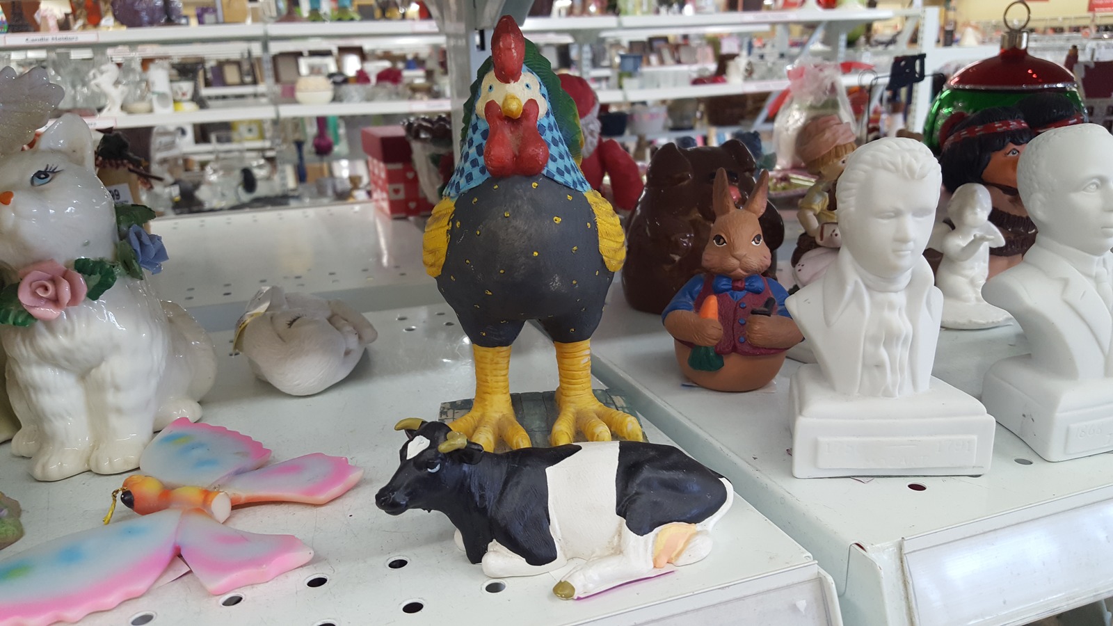 Colorful collectibles displayed beside clothing racks at Savers near Lenexa