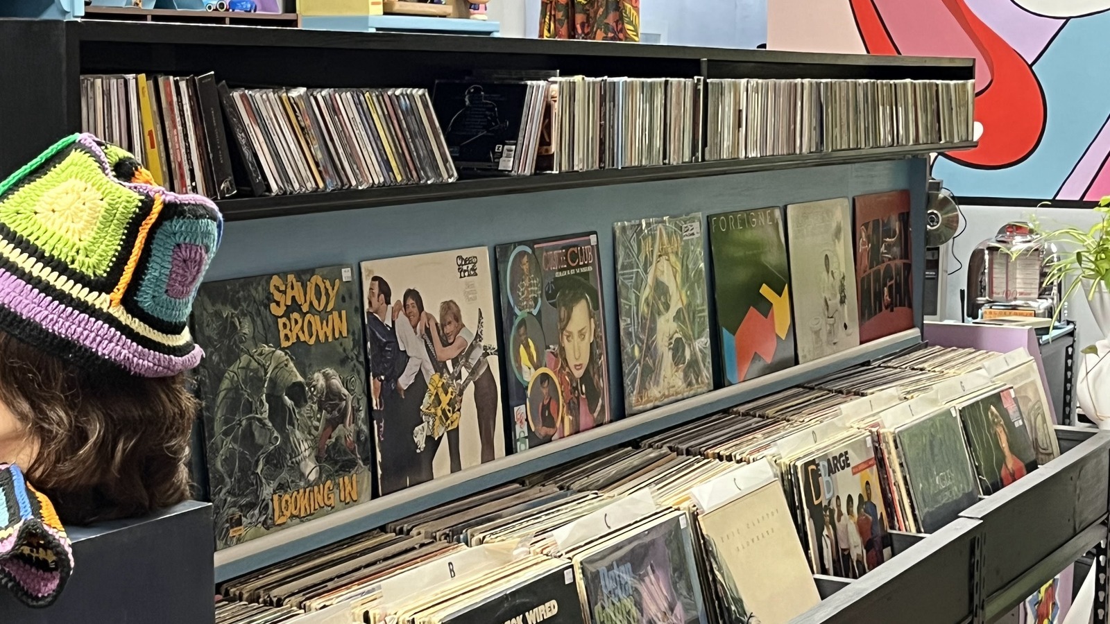 Rows of vinyl records beneath colorful pop art at Viva la Vintage in downtown Morganton