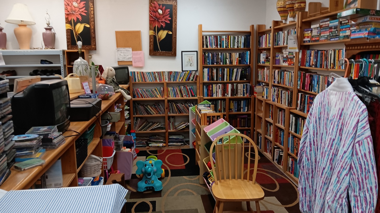 Books, clothing, and household goods inside Raising Hope Free Store in Camdenton