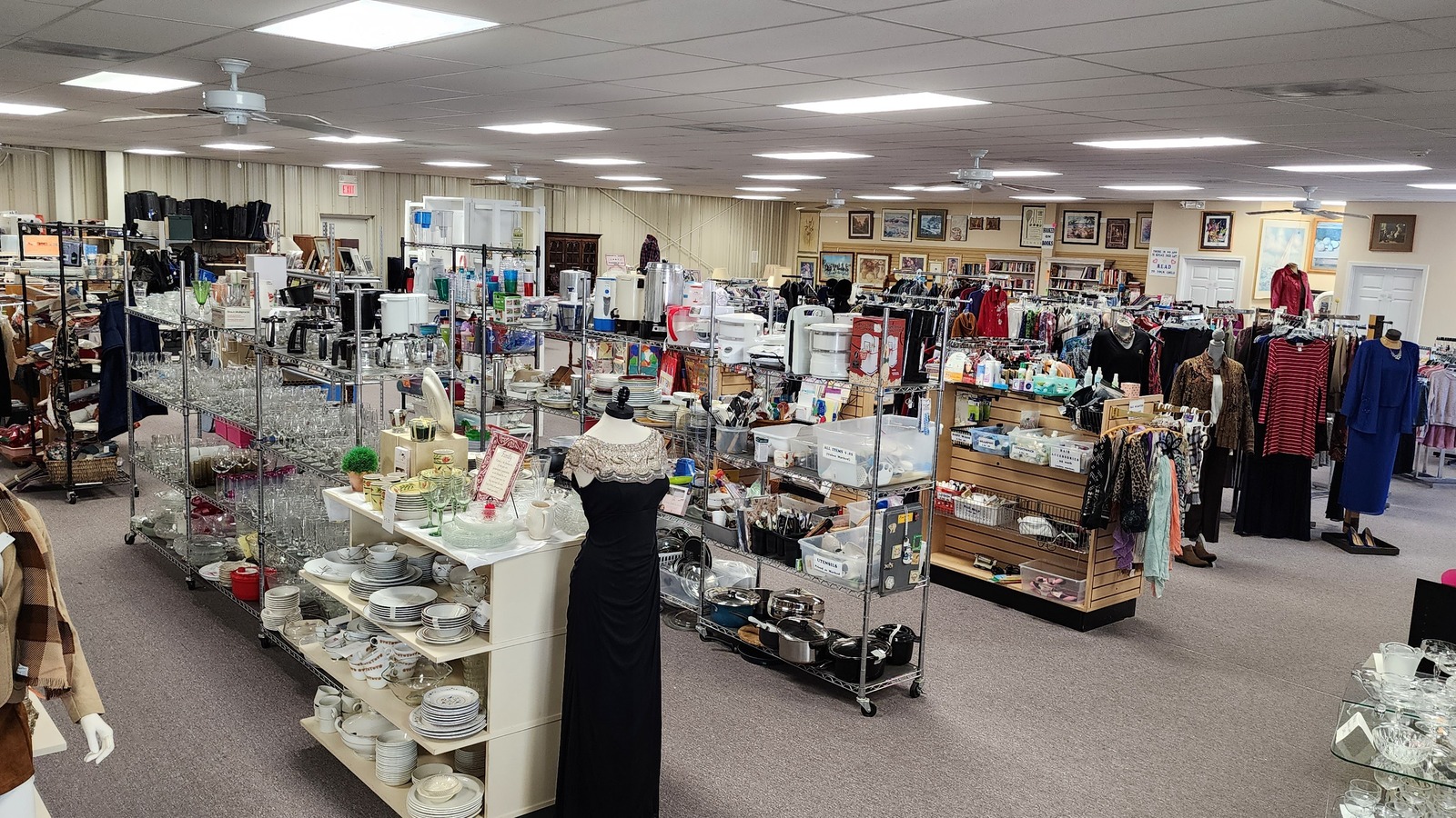 Books, clothing, and display cases at Share the Harvest thrift store near Camdenton