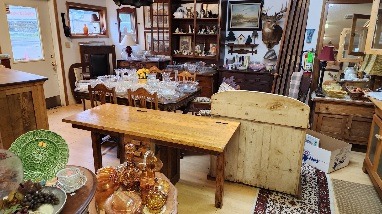 Antique furniture, signs, and collectibles inside Up North Antiques in Hayward