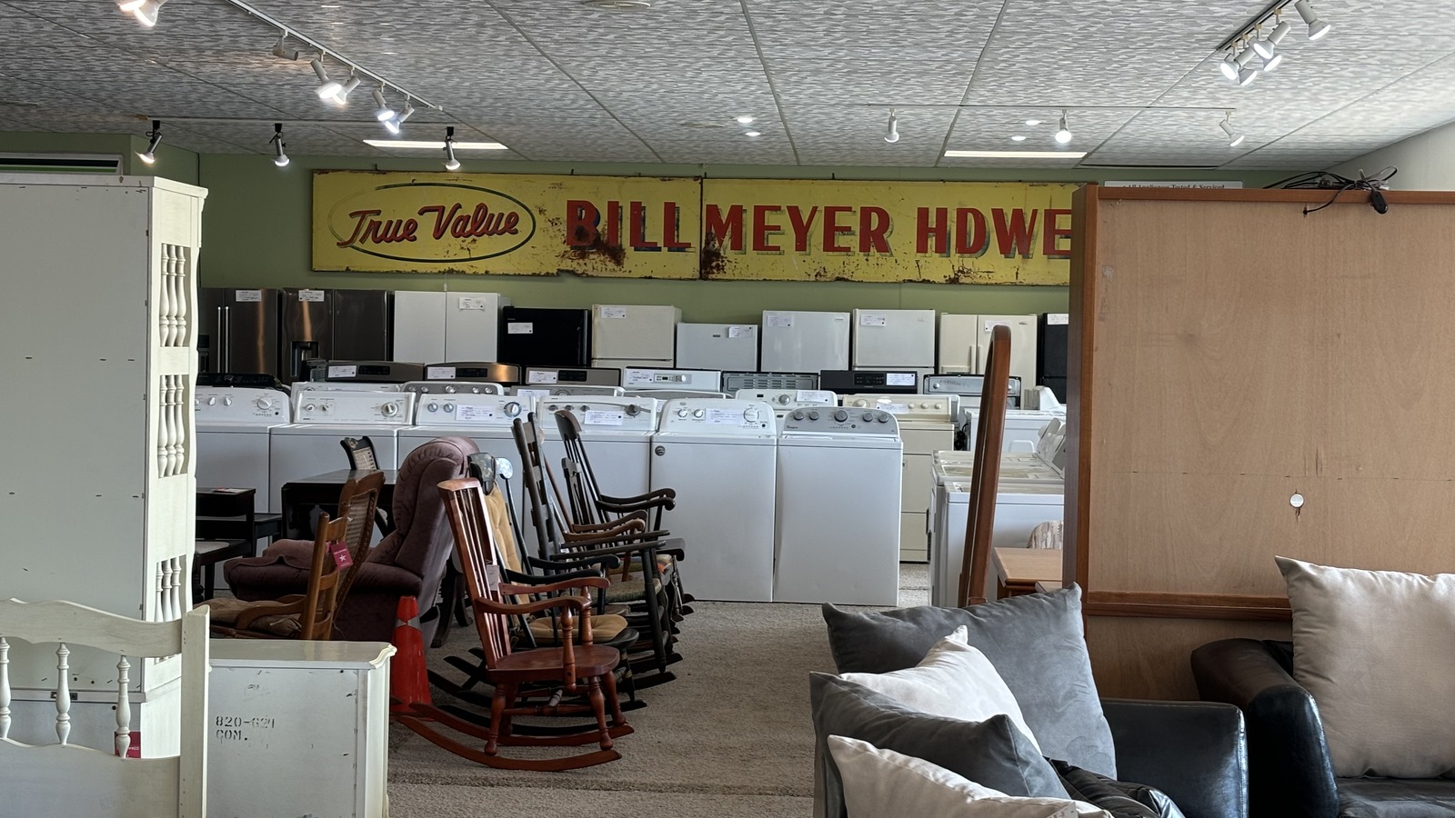 Appliances, furniture, and vintage store signs at Estate Sales Warehouse