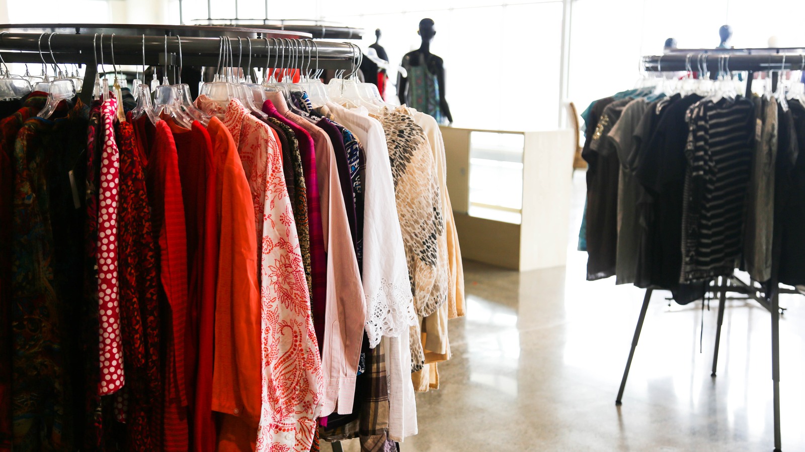 Neatly spaced clothing racks inside Gateway Mission Store in Holland