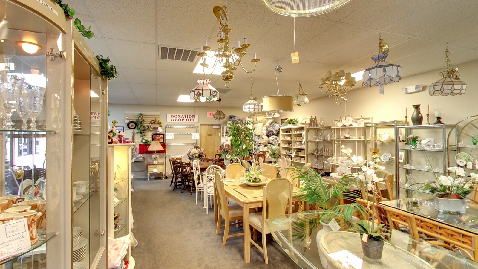 Dining furniture and glassware inside St. John XXIII Thrift Store