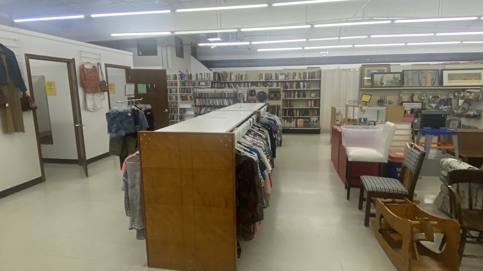 Clothing racks, books, and household finds inside Treasure Haus in New Ulm