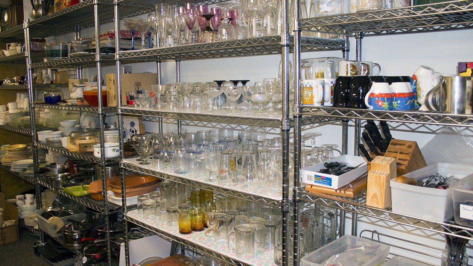 Glassware and housewares shelves at Whitefish Thrift Haus in Whitefish