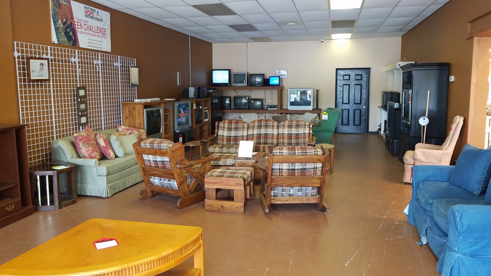 Furniture showroom with sofas tables and televisions at SuperThrift in Orange Park