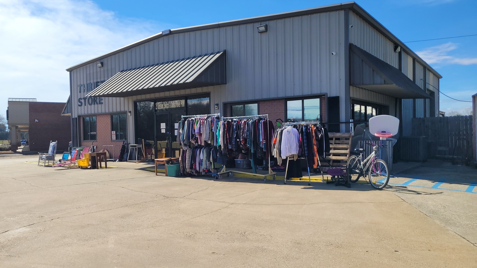Clothing racks and outdoor finds at Elmore County Food Pantry Thrift Store in Wetumpka
