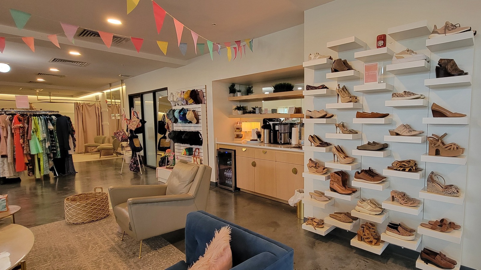 Women's shoes, boutique displays, and lounge seating at Beautiful Lives Thrift Boutique in Bentonville