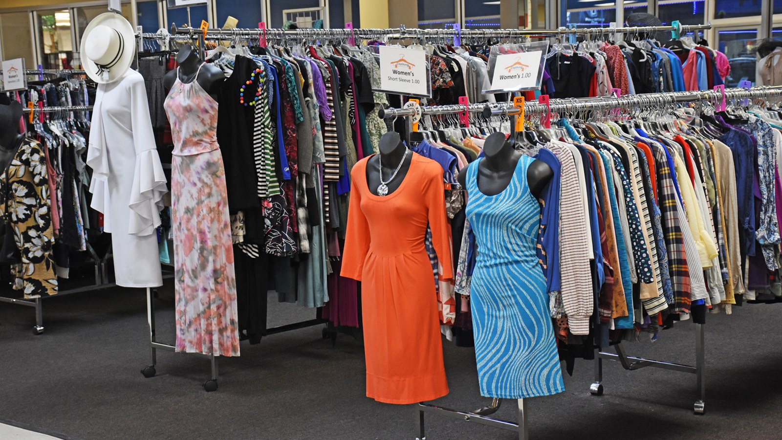 Colorful clothing racks and dresses at The Fringe Thrift Store in Bowling Green