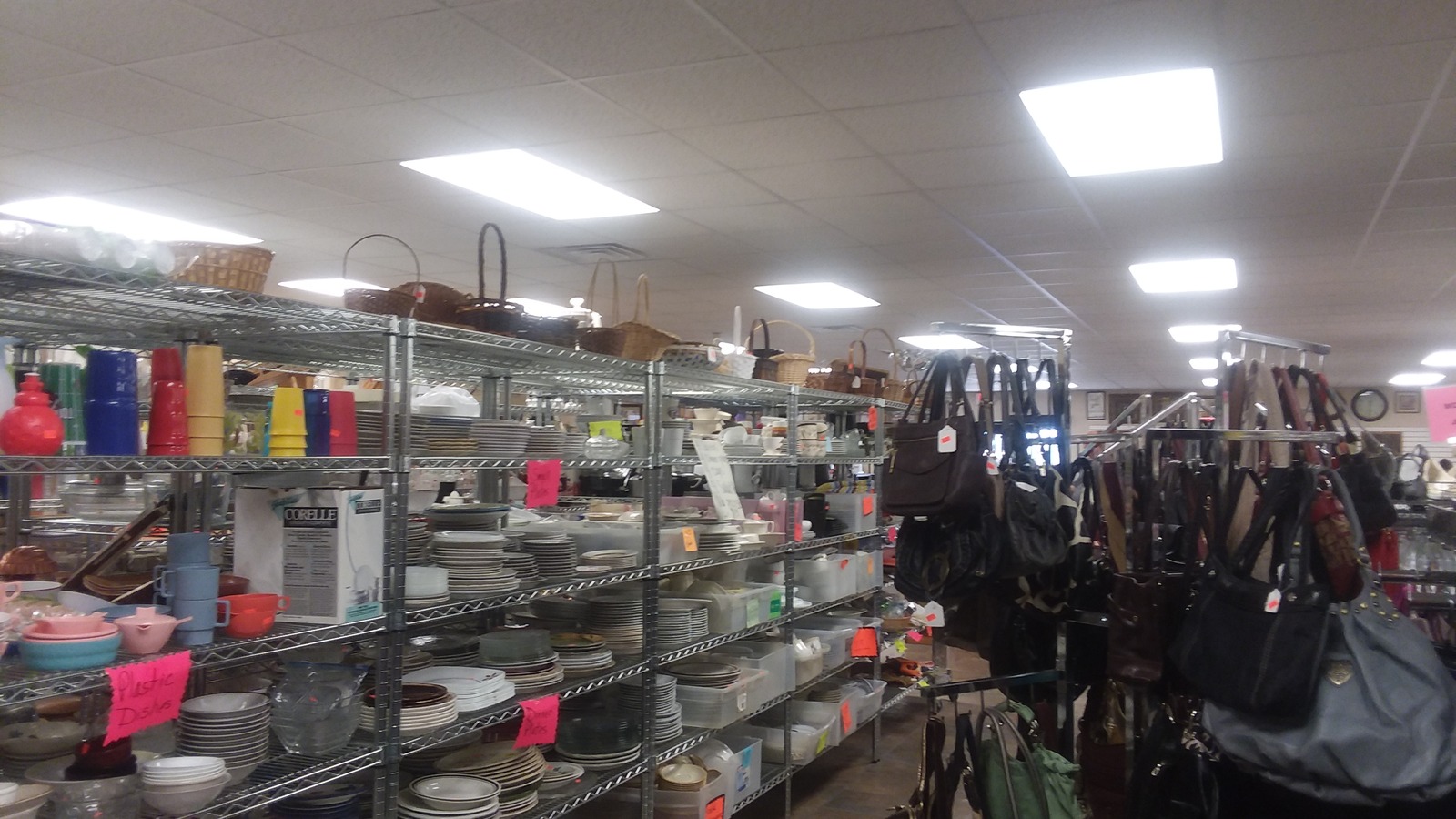 Housewares shelves and handbags inside ABLE Thrift Center in Dickinson