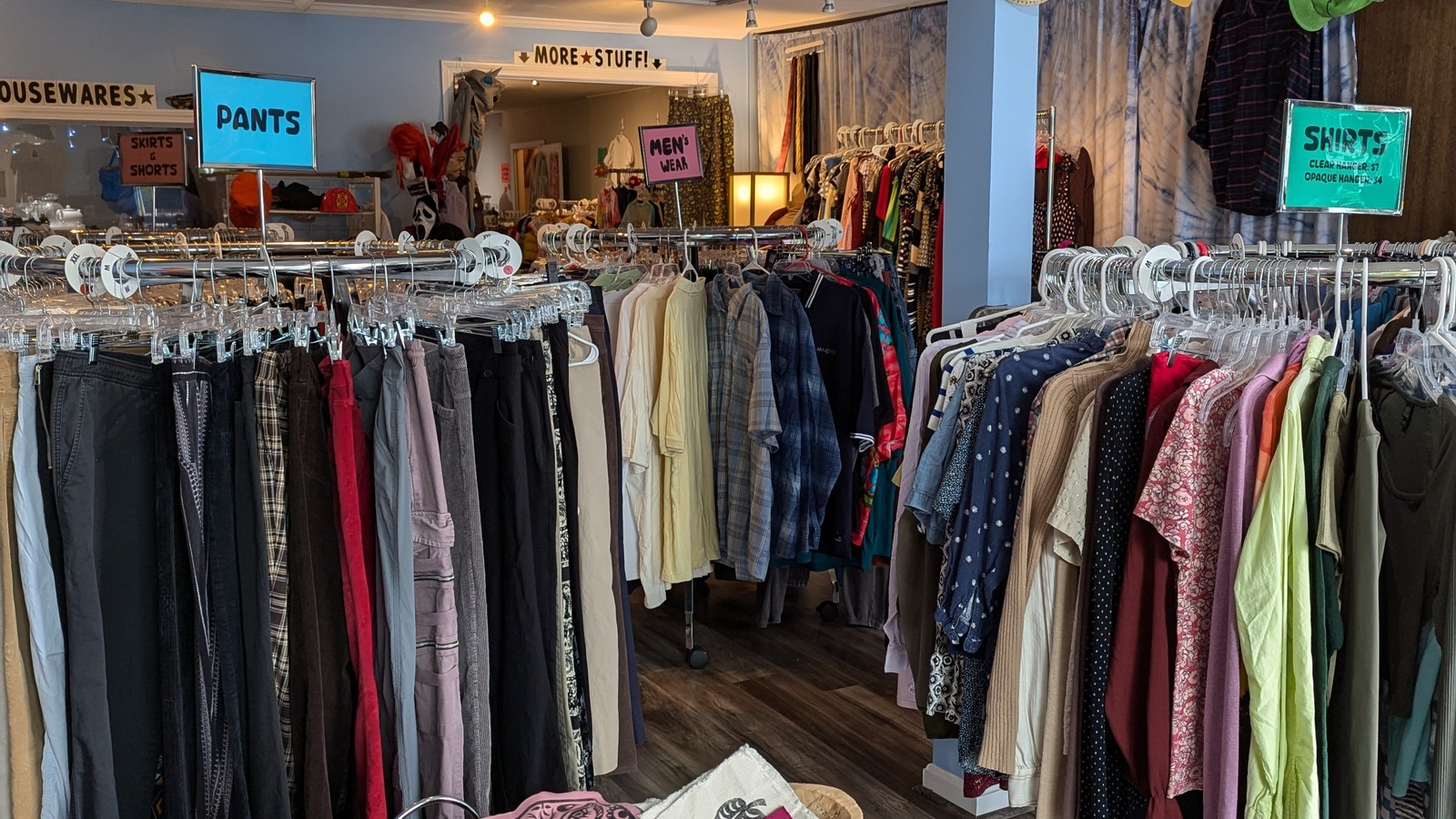 Clothing racks and hanging decor inside Thrifty Bootique in Dover
