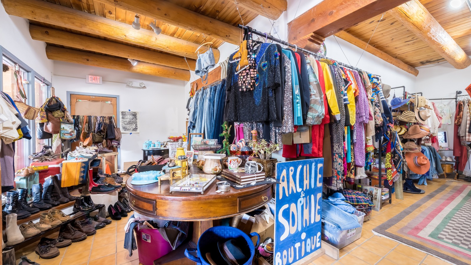 Vintage clothing racks and hats inside Sophie's World in Taos New Mexico