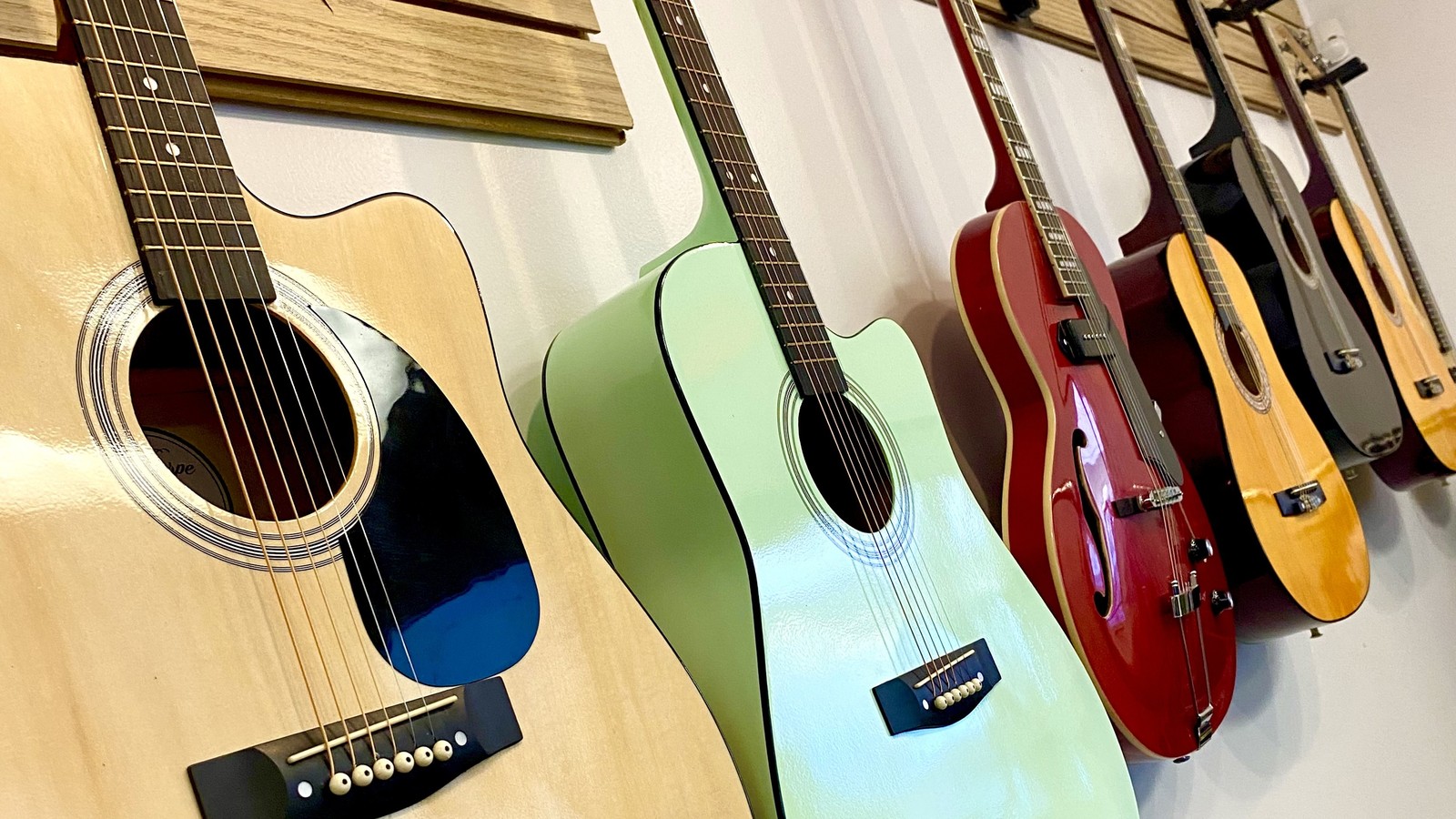 Colorful guitars hanging inside UpTown Thriftstore in Taos New Mexico