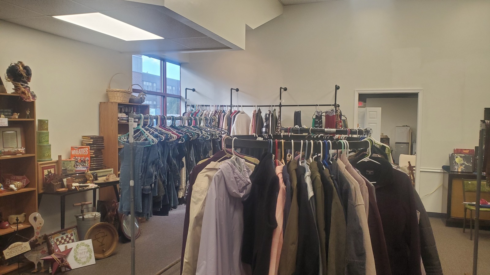 Clothing racks and small home goods inside Harvest Thrift Store in Lebanon