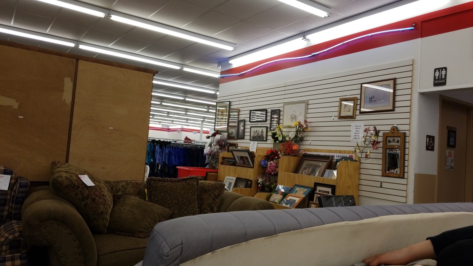 Sofas, framed art, and clothing sections inside The Salvation Army Thrift Store in Lebanon